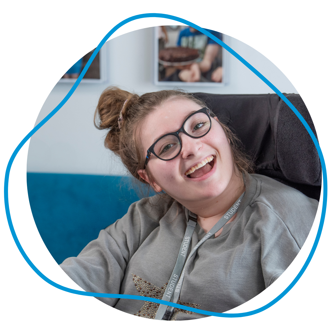 Milly Evans smiling and looking happy; she’s been using Grid with eye gaze for many years.