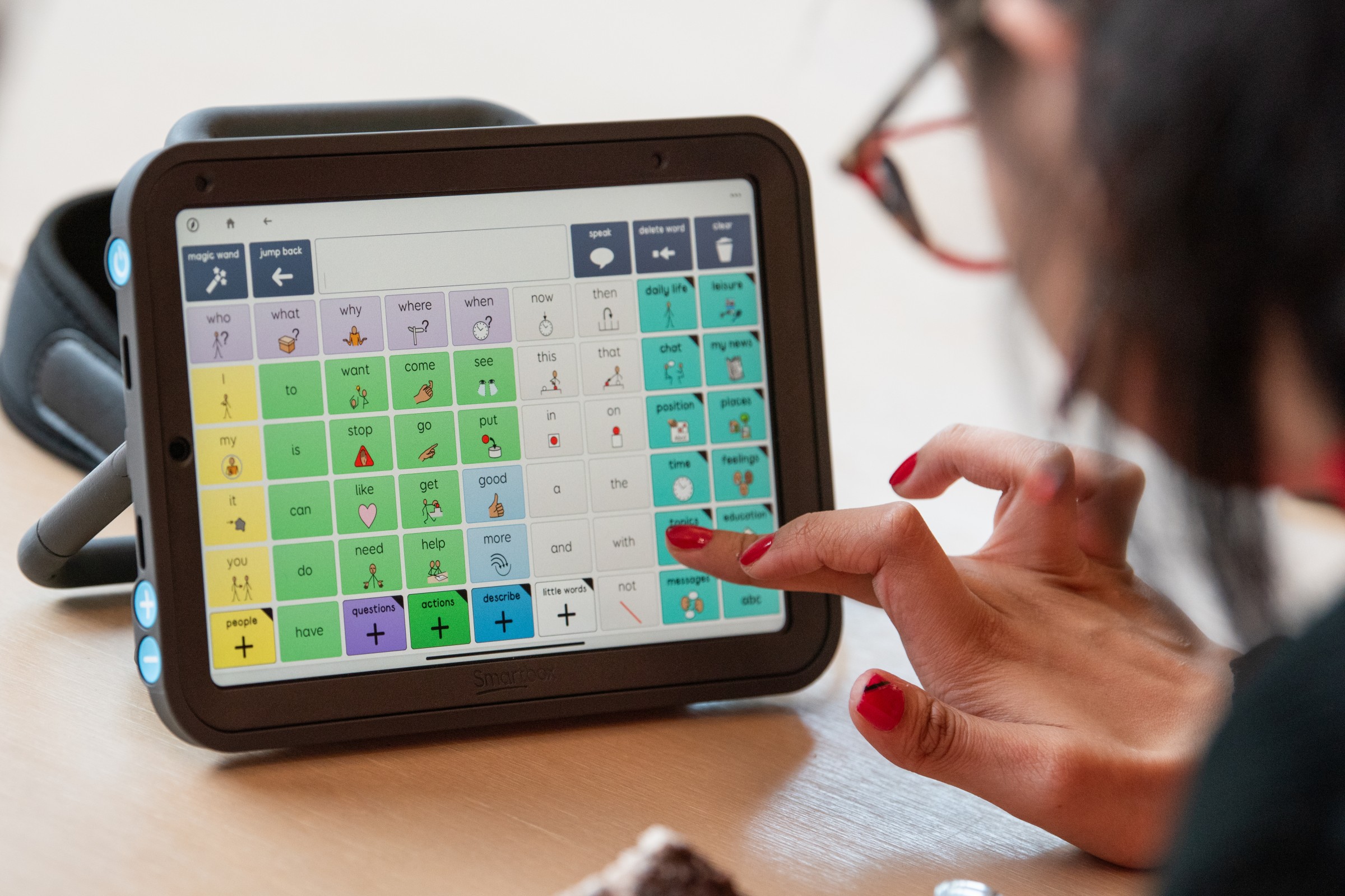 Sufina using Super Core vocabulary in Grid, on a Talk Pad device.