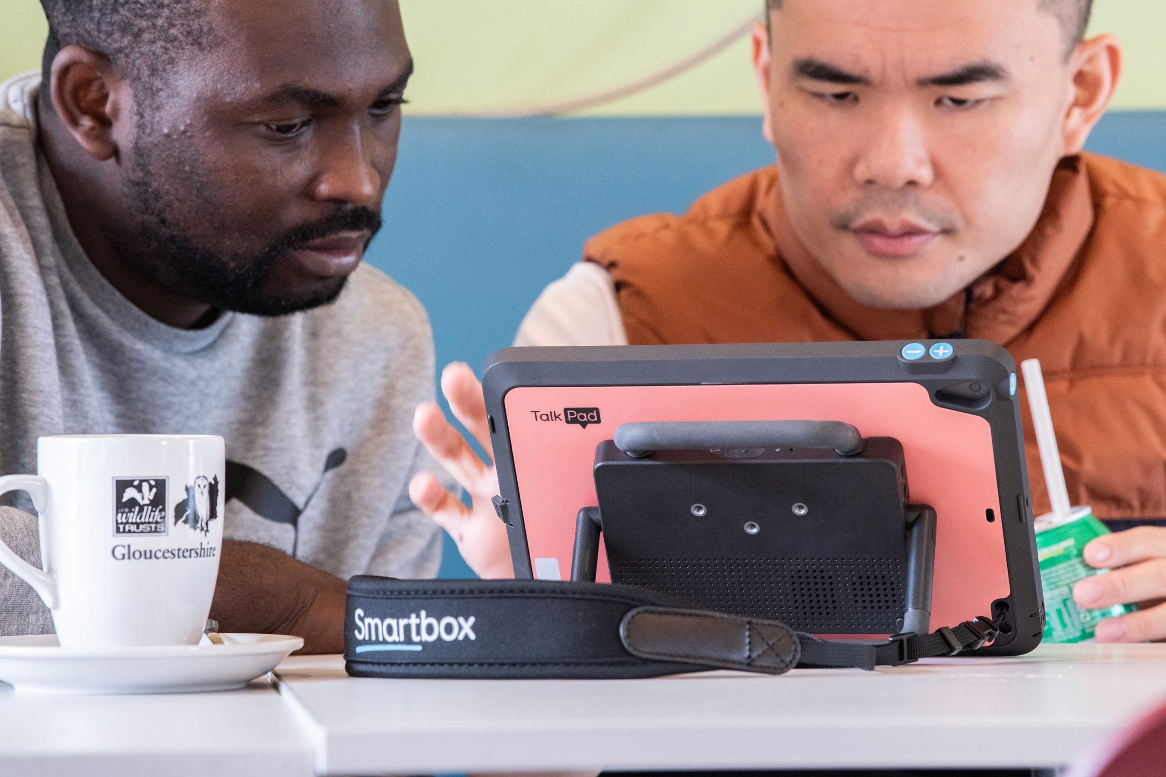 Eugene is an AAC user using the new Talk Pad in Corral pink.