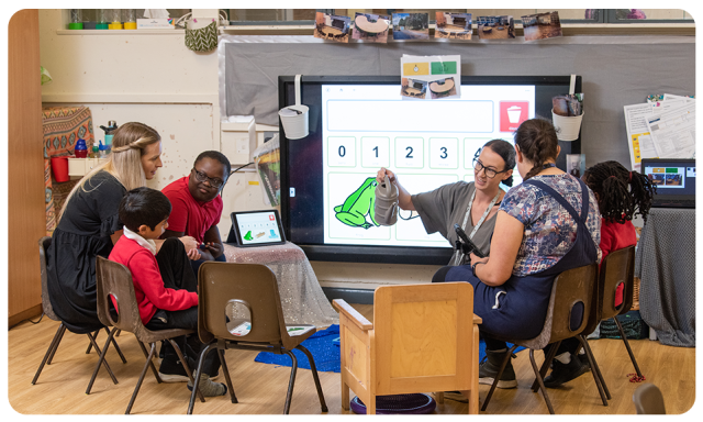 Some students and teachers using Grid in a classroom
