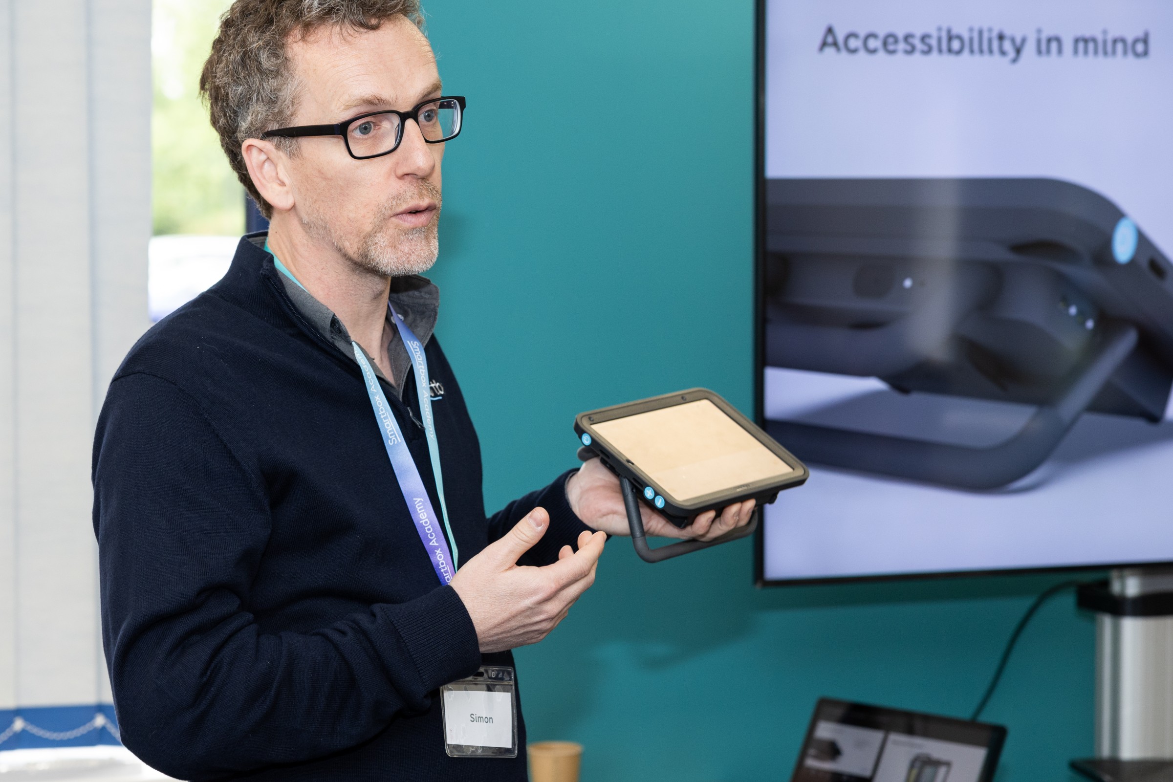 Simon presenting on product accessibility, holding a Talk Pad 8.